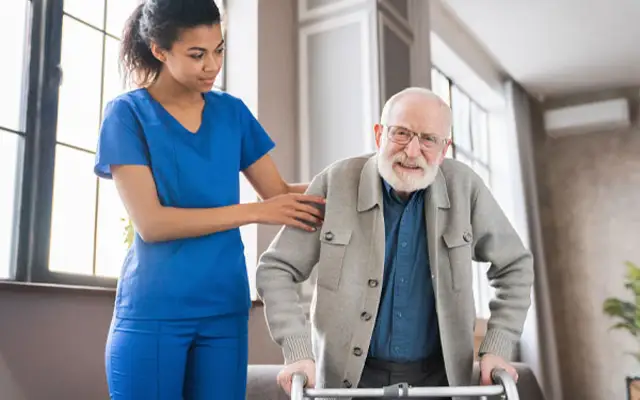 Healthcare assistant supporting an older patient